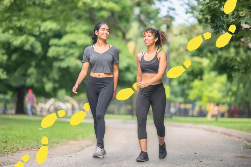 Two women walking outdoors illustrating natural gait and walking mechanics for knee pain assessment