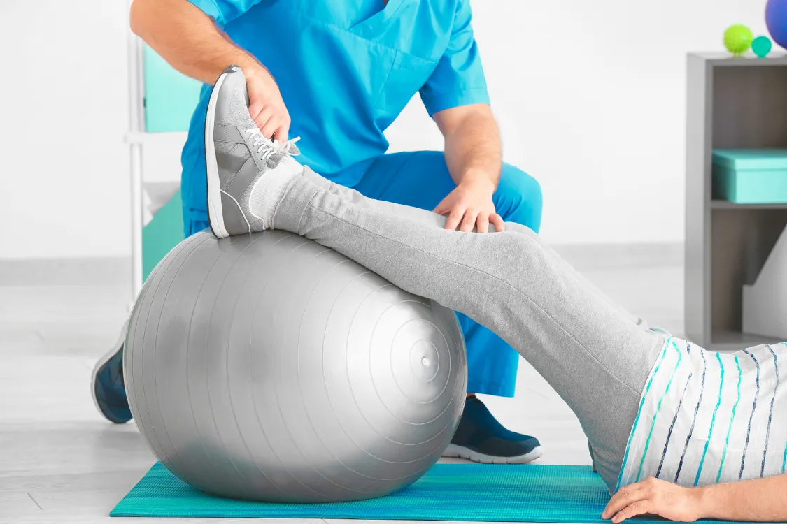 Healthcare provider greeting a patient during a consultation about non-surgical knee pain treatment options.